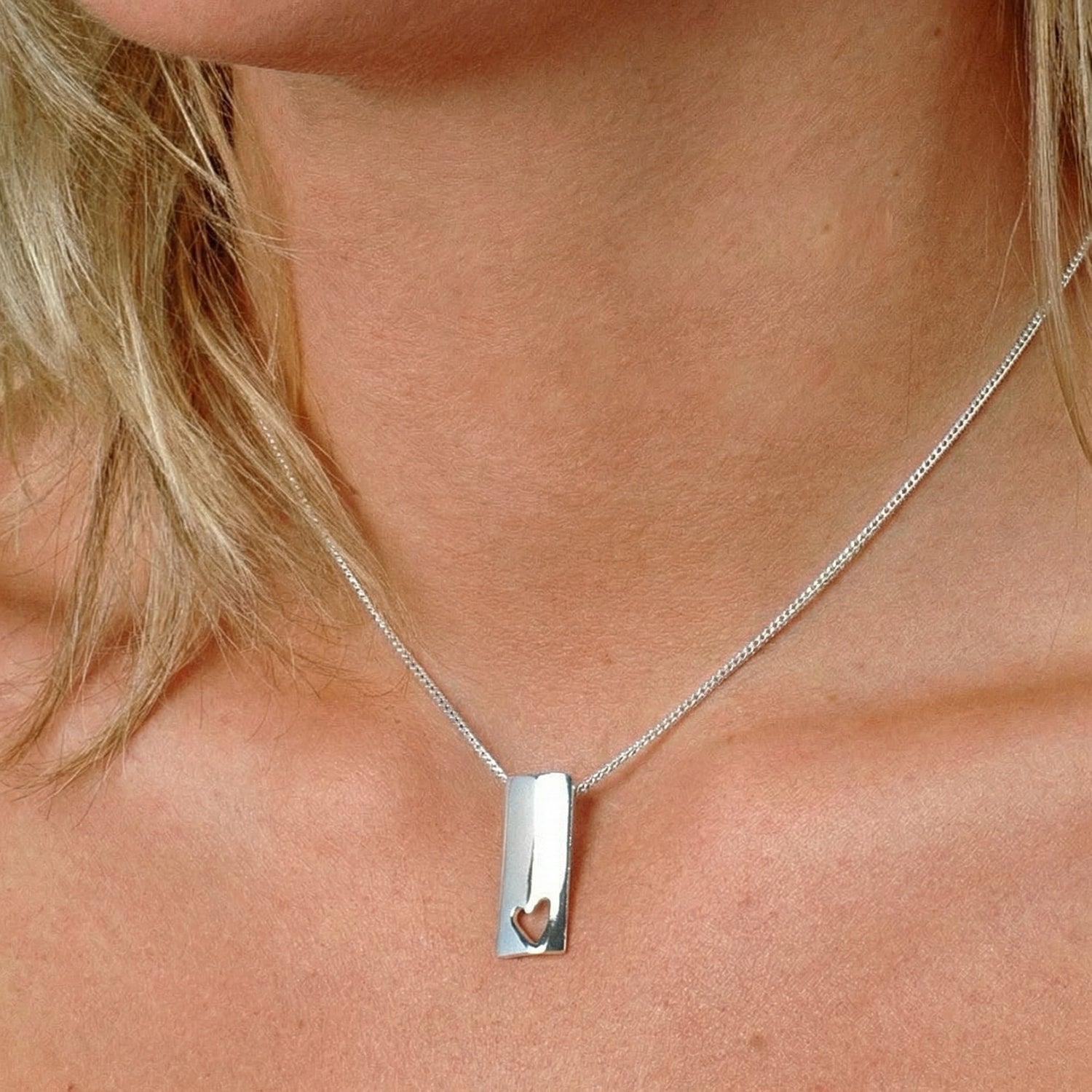 Close-up of a silver chain necklace resting on a neck