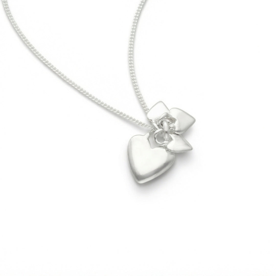 Sterling silver heart pendant with a flower motif on a silver chain