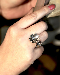 Close up of GULLVIVA silver flower ring on finger highlighting petal detail