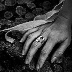Hand wearing STORMSKÄRS MAJA FEST ring with overlapping bold sterling silver bands.