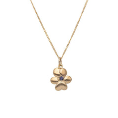 Halsband i 18K guld med en blomformad berlock och en central finsk kordierit sten.
